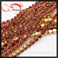 long decorative brass chain with garnet crystal